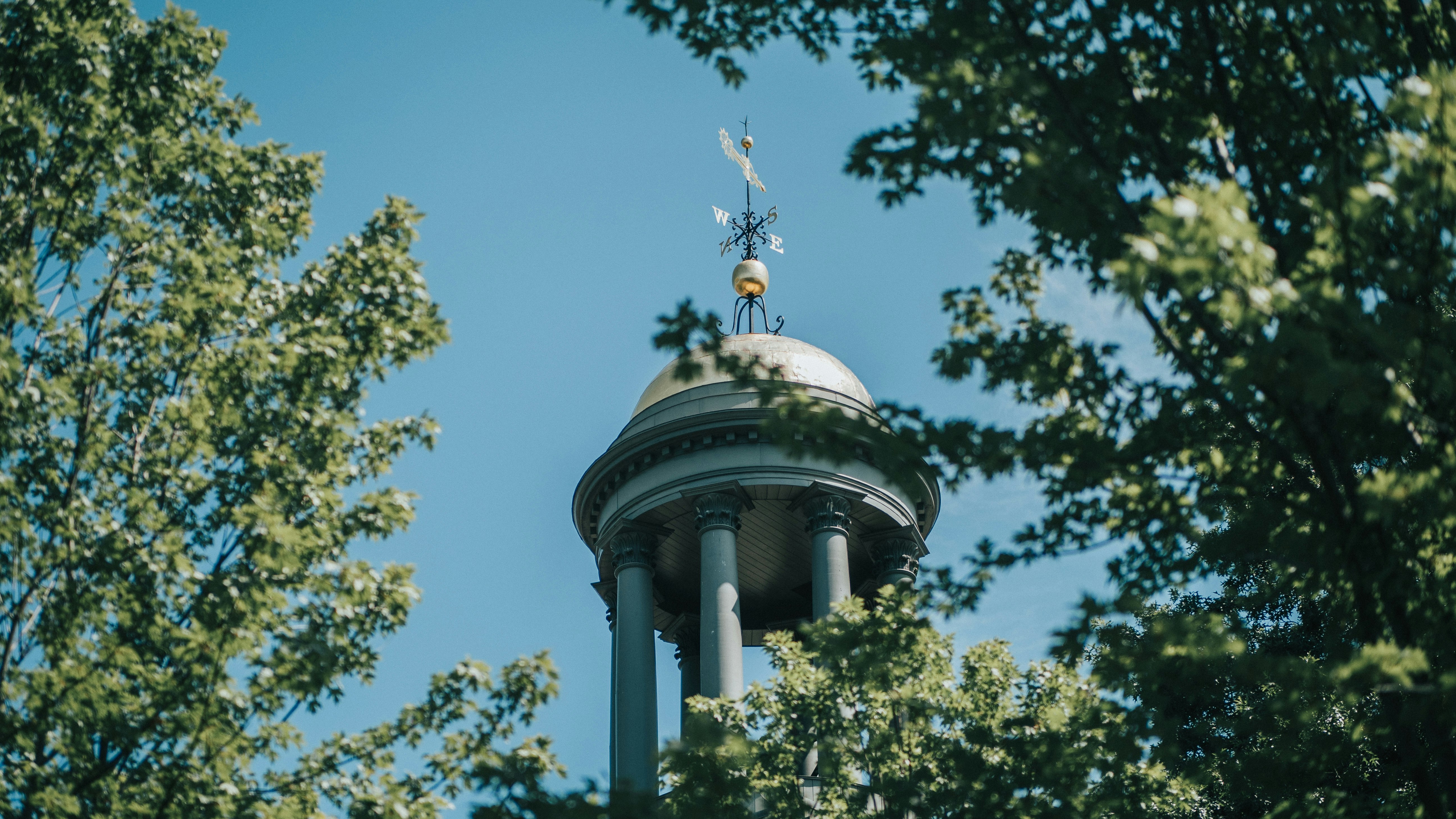 high angle photo of white concrete tower near trees